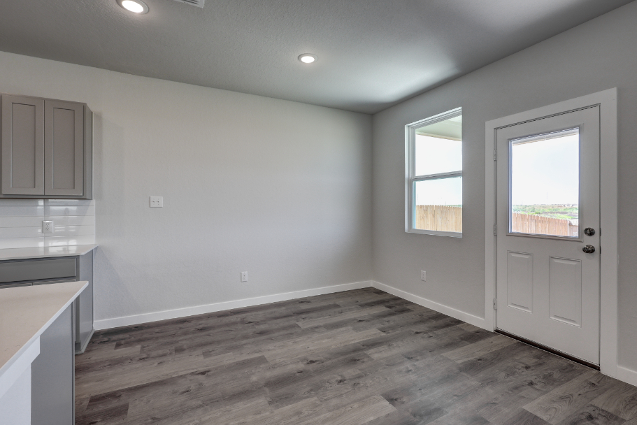 A room with a wood floor and a white door.