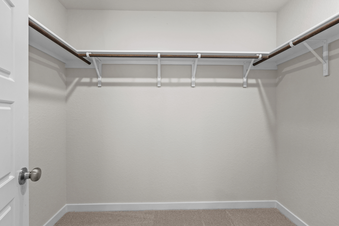 A white wall with a metal railing.