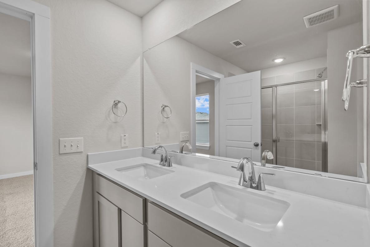 A bathroom with a large mirror.