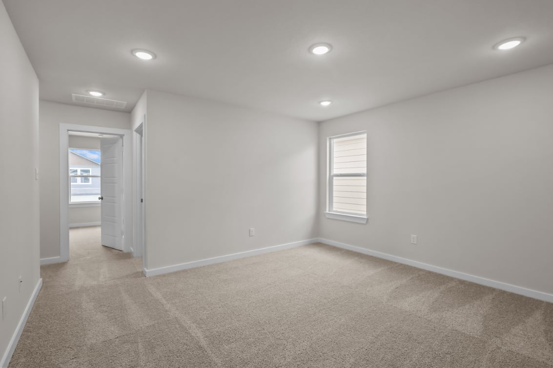A room with a carpet and a door.
