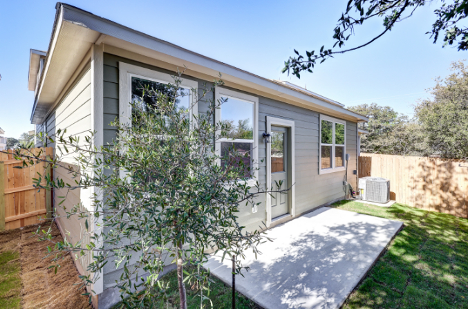A house with a tree in the front yard.