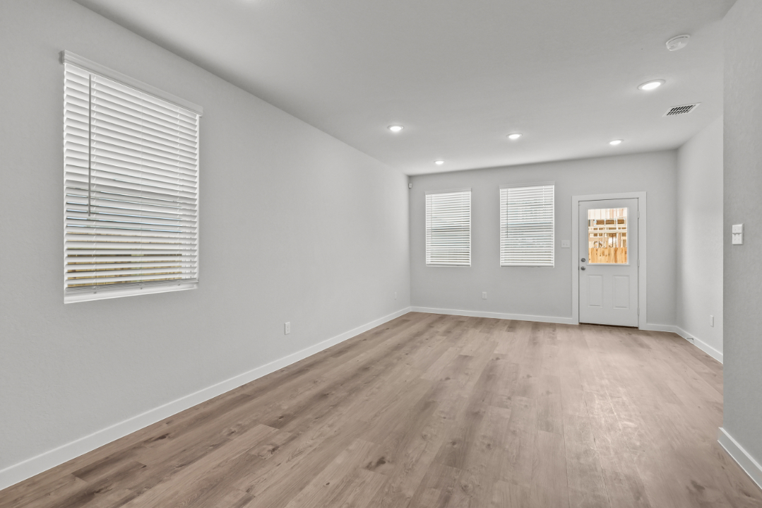 A room with white walls and a wood floor.