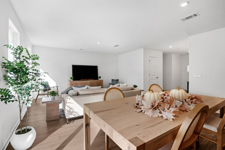 A living room with a table and chairs.