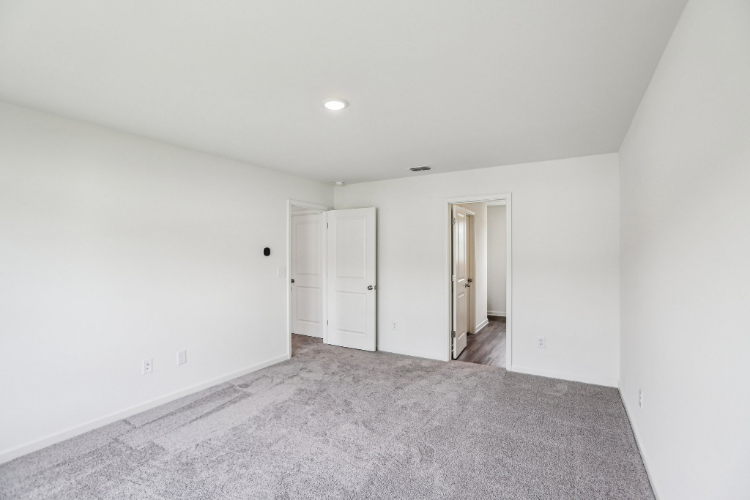 A hallway with white doors.