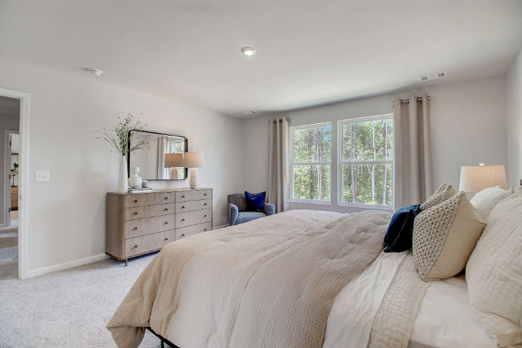 A bedroom with a bed and a dresser.
