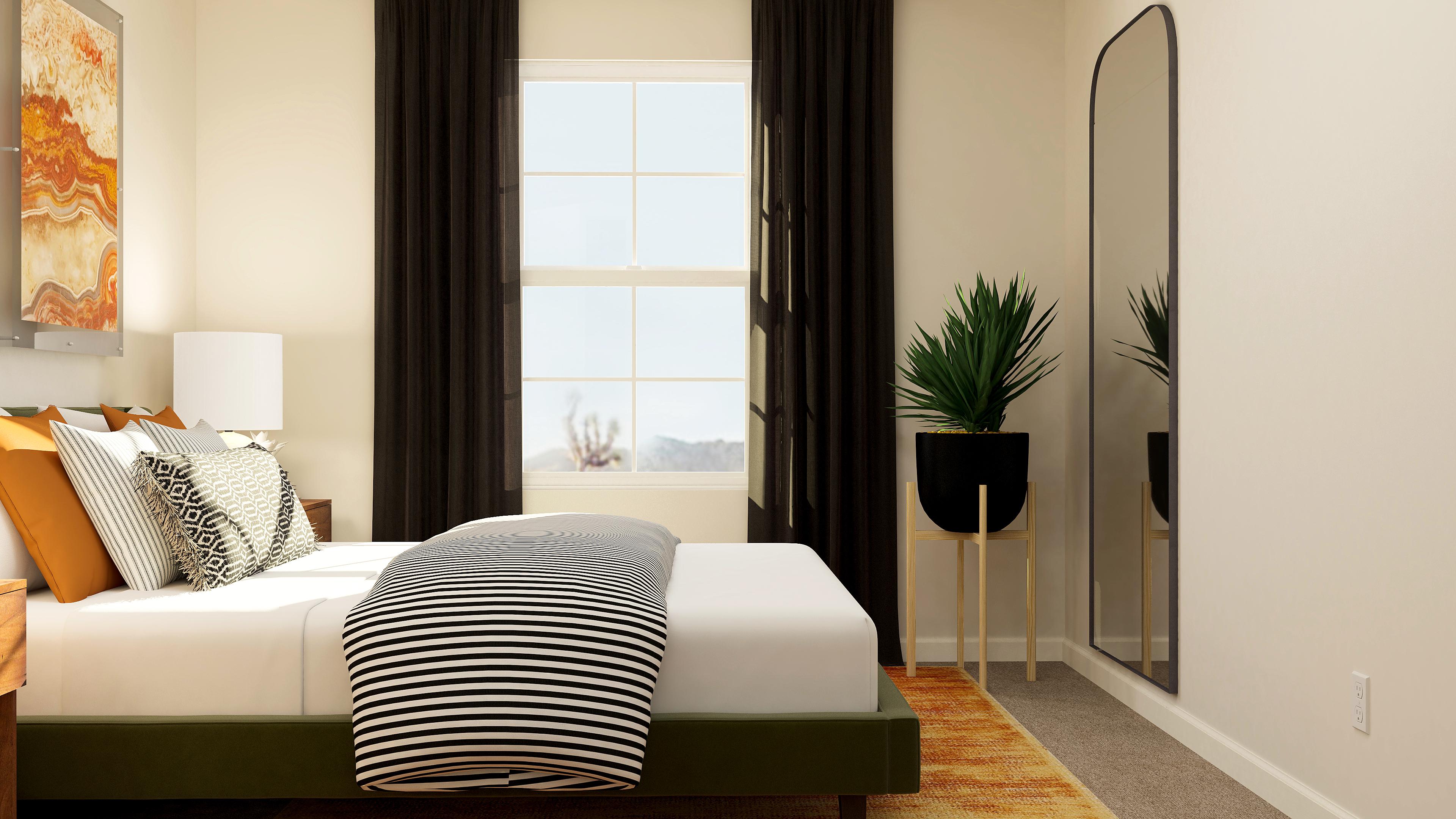 A bedroom with a large window.