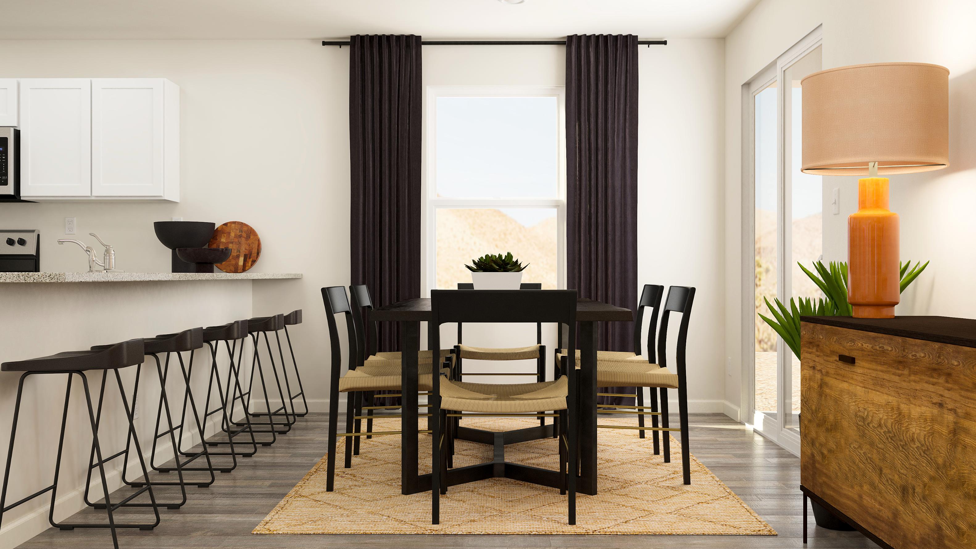 A dining room with a table and chairs.