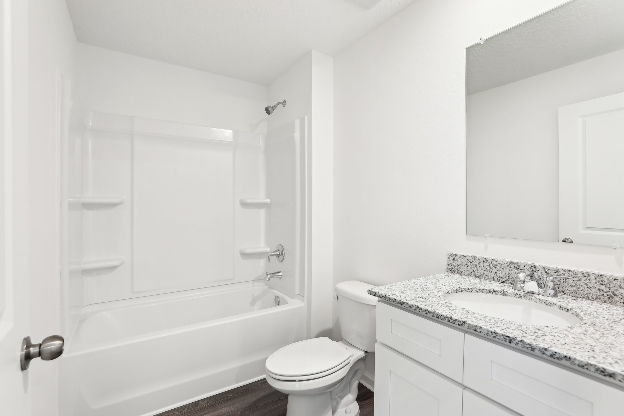A bathroom with a tub sink and toilet.