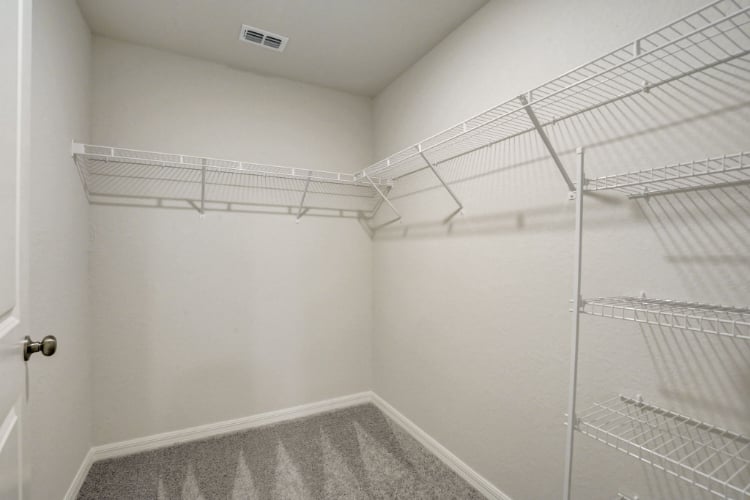 A white room with a metal rack.