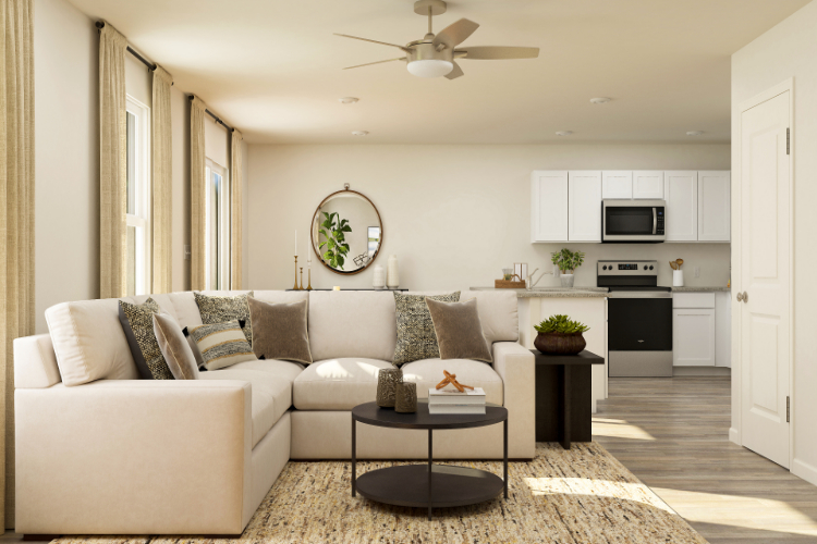 A living room with a white couch and a white table.