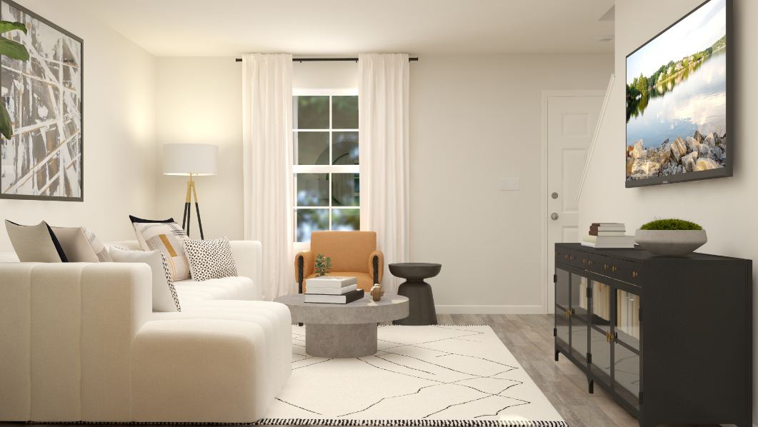 A living room with a white couch and a coffee table.