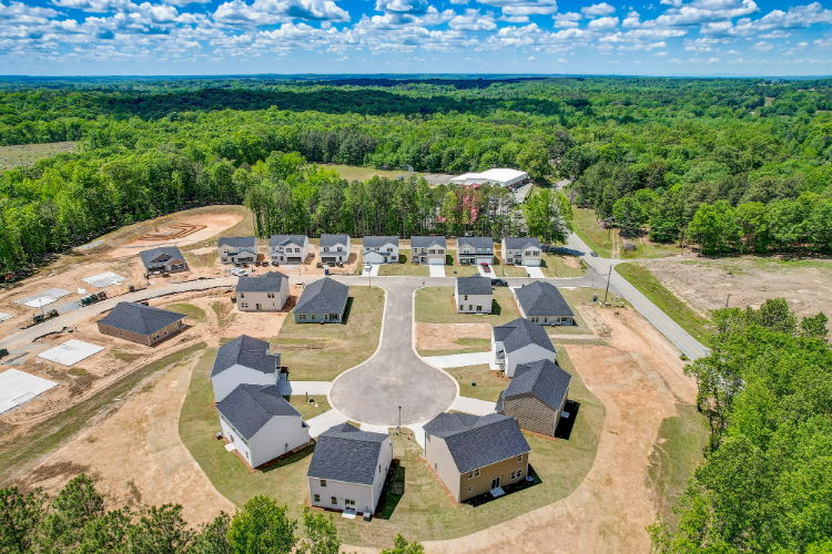 A group of buildings surrounded by trees.
