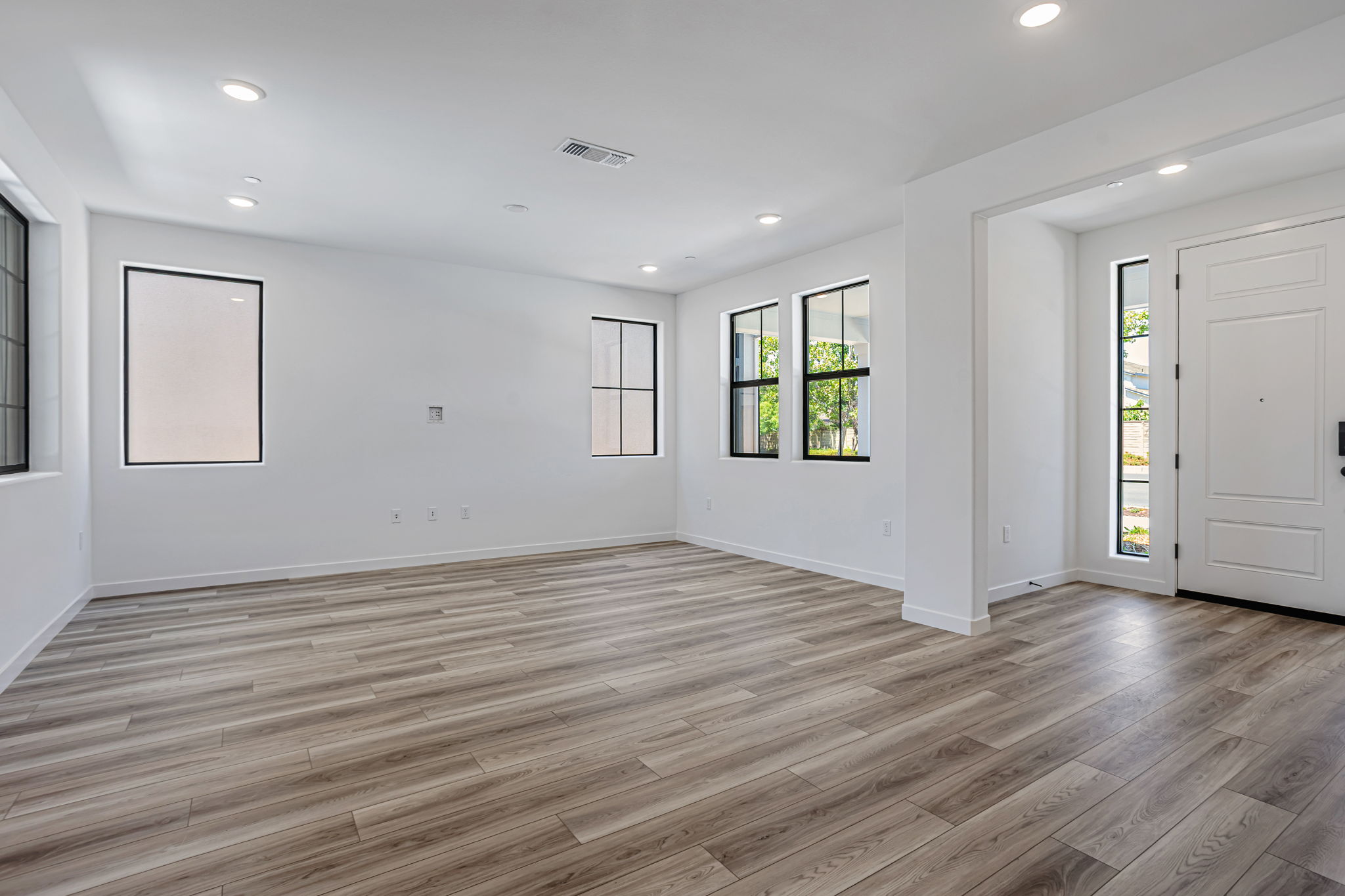 A room with a wood floor and white walls.