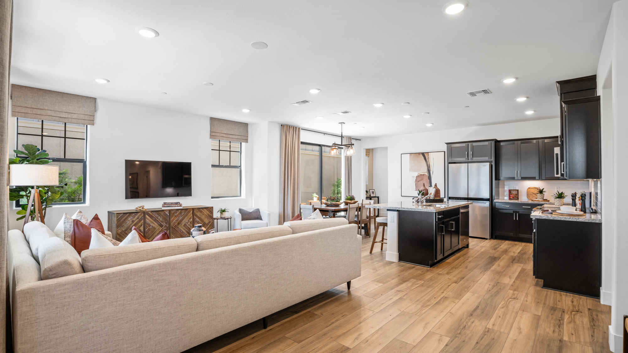 A large living room with a large couch and a tv.