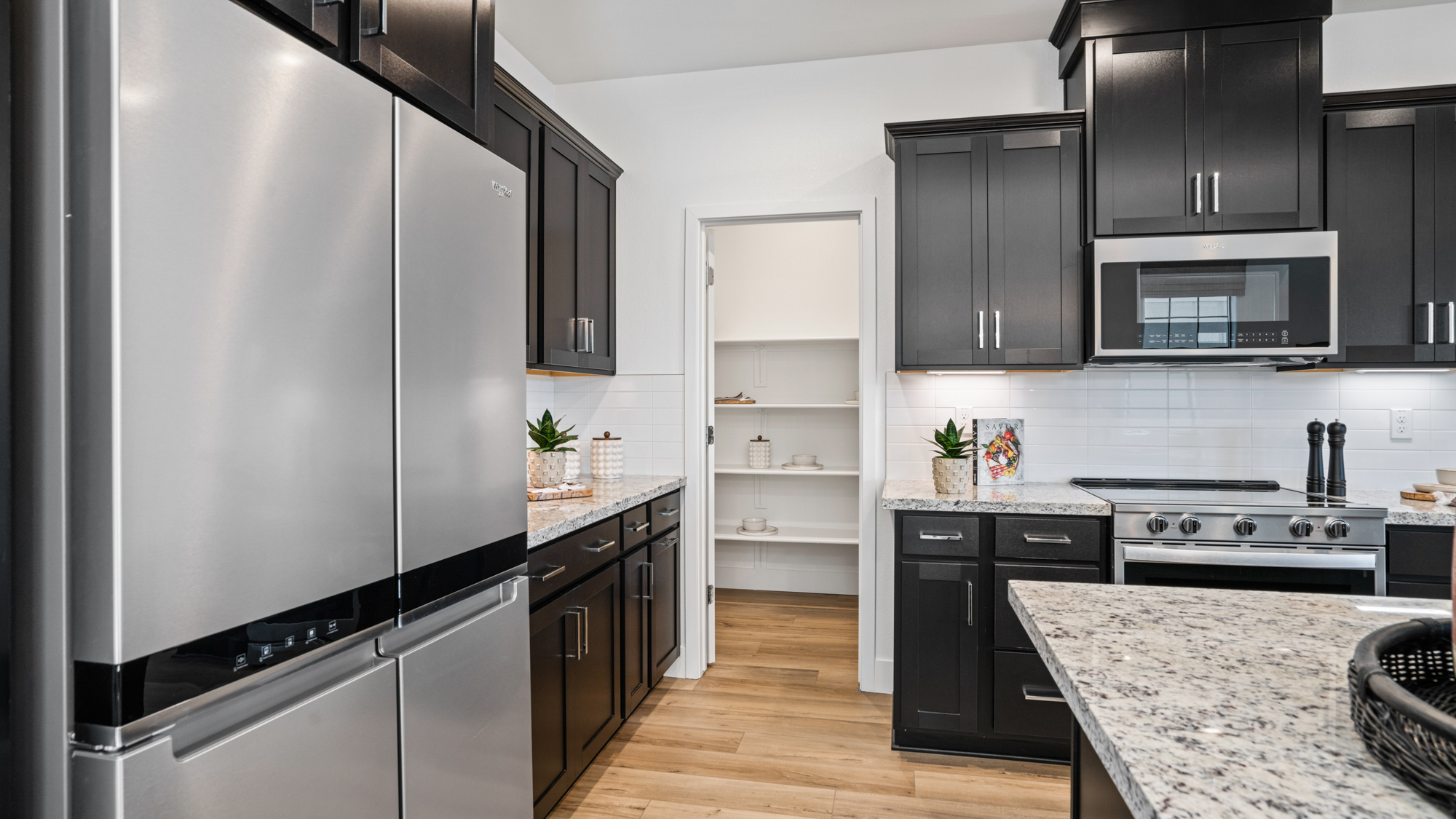 A kitchen with black cabinets.